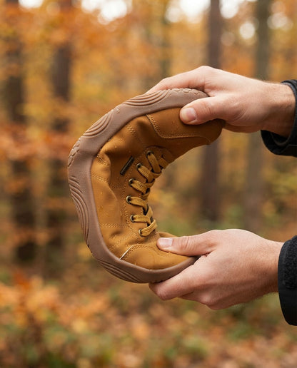 Hands flexing a Canyon Barefoot Boot to show the flexible sole