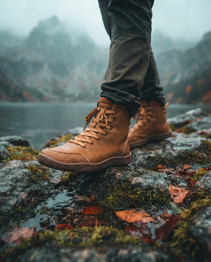 Canyon Barefoot Boots lifestyle - walking on wet rocks by an autumn mountain lake